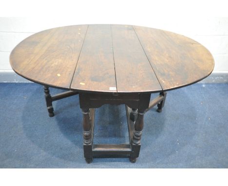 A GEORGIAN OAK GATE LEG TABLE, the oval top on turned and blocks legs, with a single drawer, open length 146cm x closed lengt