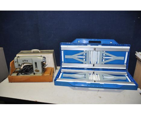 A VINTAGE DELSO DELUXE ELECTRIC SEWING MACHINE (bare cables so untested) and a plastic folding Picnic table in the form of a 