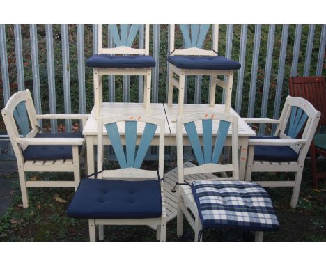 A CREAM PAINTED RECTANGULAR EXTENDING TEAK SLATTED GARDEN TABLE, closed width 133cm x open width 179cm x depth 92cm with six 