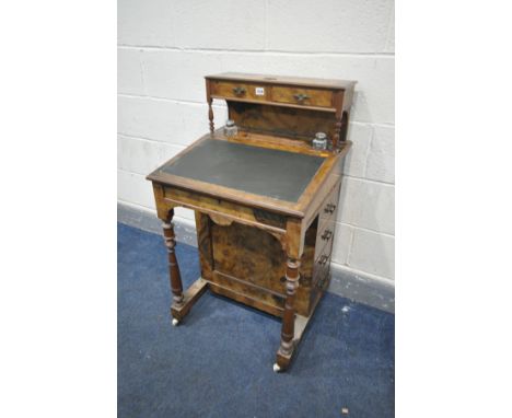 A LATE VICTORIAN BURR WALNUT DAVENPORT, the overhanging top with two drawer, above a leatherette skiver, revealing a fitted i