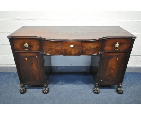 A GEORGE IV MAHOGANY PEDESTAL SIDEBOARD, with one short and two long frieze drawers, with brass lions mask handles, over pede