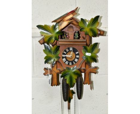 A FORESTALL CUCKOO CLOCK, with dancing couples, pinecone weights and original tag (Condition report: missing number I, top br