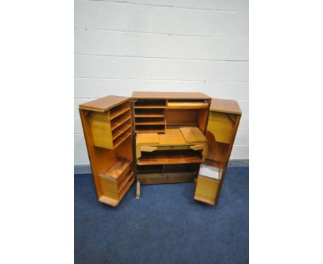 A MID CENTURY TEAK 'MAGIC BOX' FOLD OUT DESK/WORK STATION, BY MUMMENTHALER &amp; MEIER, the double door opening to revealing 