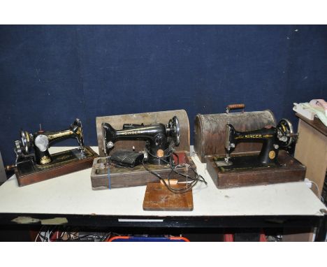THREE VINTAGE SINGER SEWING MACHINES, two with distressed domed cases (one key) one electric but untested