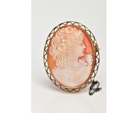 A PORTRAIT CAMEO BROOCH, set in an a 9ct gold open work mount, portrait depicting a lady facing to the right with flowers in 
