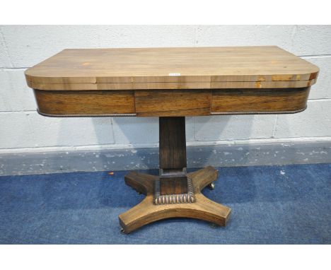 A REGENCY ROSEWOOD CARD TABLE, the fold over top enclosing a green playing surface, on a square tapered support, and quad for