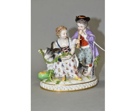 A LATE 19TH CENTURY MEISSEN FIGURE GROUP OF A BOY AND A GIRL WITH A GOAT, the boy playing a wind instrument, the girl holding