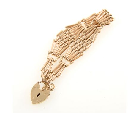 A yellow metal five bar tapered gate link bracelet, maximum 12cm wide fitted with a 9 carat yellow gold padlock fastener, app