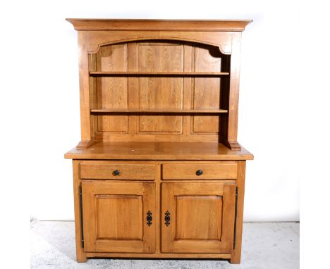 A modern light oak dresser, with a two-shelf delft rack, base with two drawers over two panelled doors, width 140cm, height 1