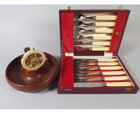 A Ships Wheel Nut Cracker and Set of Fish Knives and Forks