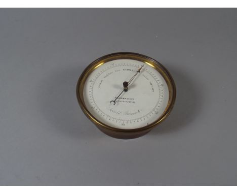 A Brass Cased Circular Aneroid Barometer by Tanner & Son, Cirencester