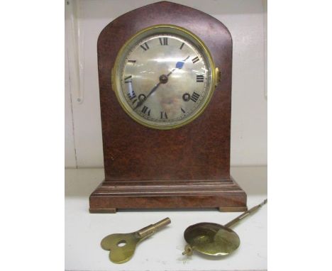 An early 20th burr maple cased mantle clock with a key 