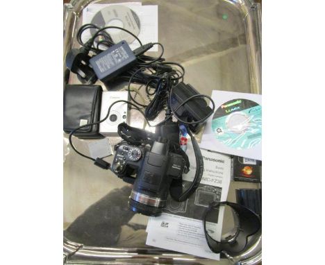 A Panasonic digital camera model no DMC F238 with software, operating instructions and accessories, and a Canon digital 1xUS7