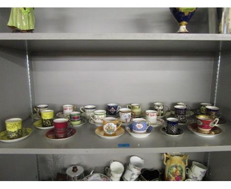 A collection of late 19th/early 20th century porcelain coffee cans and cabinet cups and saucers, some with silver cup holders