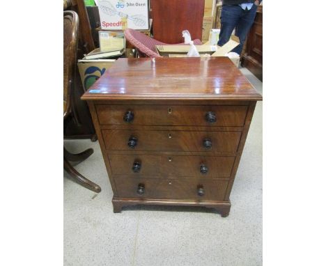 A Georgian mahogany commode with hinged lid, fitted interior and twin brass carrying handles, on bracket feet 