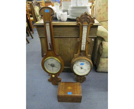 A Victorian walnut cased wheel barometer with turned ivory adjustable button, a later carved oak cased aneroid barometer and 