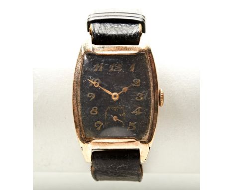 SWISS TONNEAU 9CT MANUAL WIND WRISTWATCH, c1930, with marked STOLKACE case by George Stoll, the black dial with raised gold A