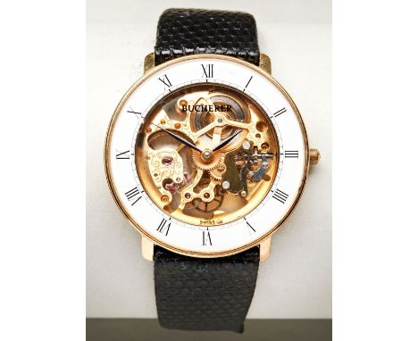 BUCHERER GOLD PLATED MANUAL WIND SKELETON WATCH, the white chapter ring with Roman numerals surrounding a visible hand engrav