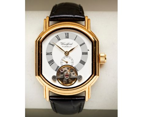 WOODFORD VISIBLE ESCAPEMENT MANUAL WIND WRISTWATCH, gold plated with leather strap. PROVENANCE: The Collection of Stuart East