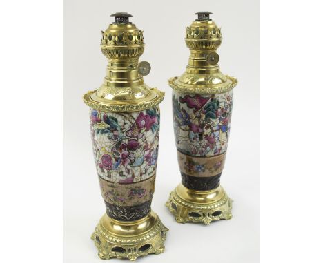 TABLE OIL LAMPS, a pair, adapted from Oriental ceramic famille rouge vases, each 42cm H overall. (2)