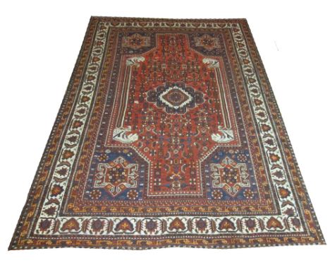 FINE QUASQAI CARPET, 300cm x 213cm, central medallion on a terracotta field of stylised vines and flowerheads inside midnight