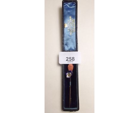 An enamelled pansy stick pin and carved coral stick pin in fitted box 