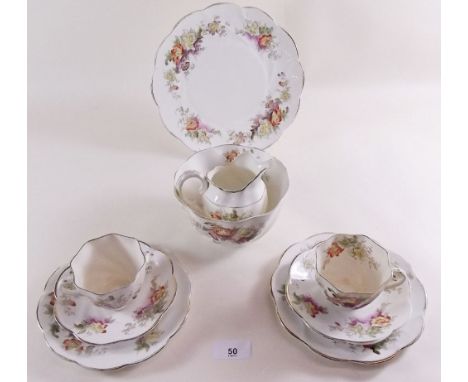 A Victorian 'Queens China' floral tea service comprising: twelve cups and saucers, eleven tea plates, cake plate, jug and two