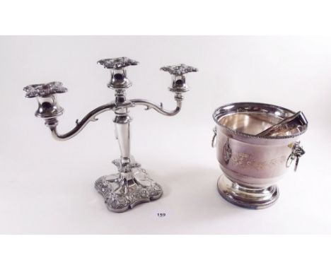 A silver plated ice bucket and tongs and a silver plated candelabra 