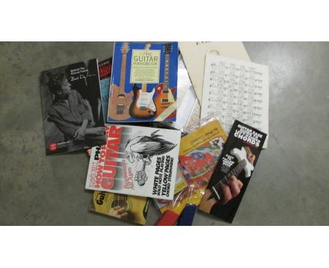A large lot of guitar tuition books including an Ernie Ball and Harmonica.