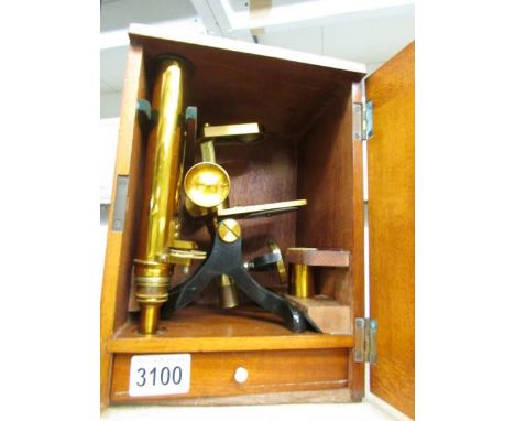 A cased brass microscope.