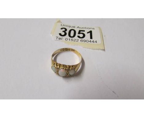 An 18ct gold ring set 3 opals, size P, total weight 1.8 grams.