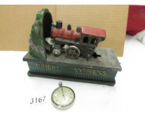 A vintage railway timekeeper pocket watch and a cast iron Orient Express money box, both a/f.