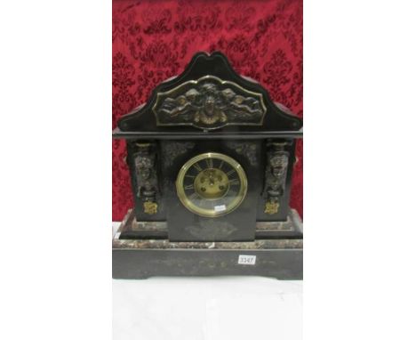 A Victorian black marble mantle clock with ormolu mounts.