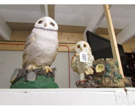A large owl and an owl planter.