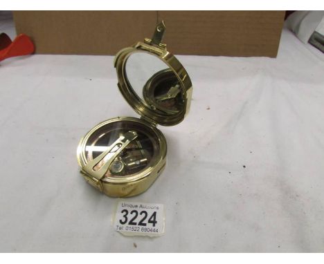 A brass compass.