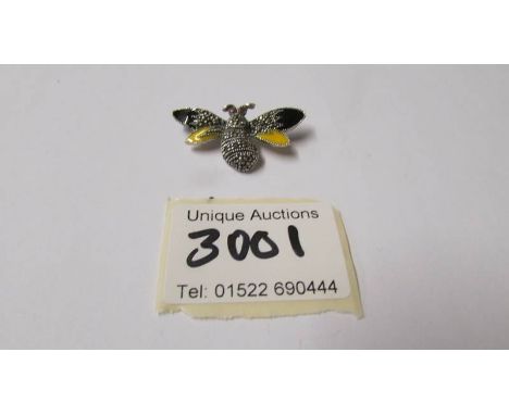 A silver marcasite and enamel bee brooch.