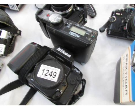 A Nikon F90 camera with speedlight SB27.