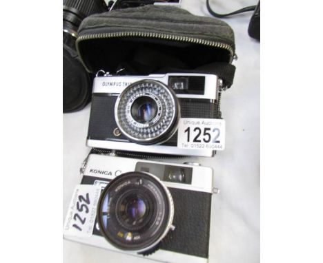 A Konica C35 camera and an Olympus Trip 35 camera.