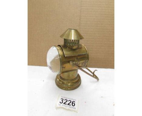 An early 20th century novelty inkwell in the form of a veteran car lamp.
