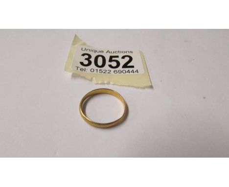 A 22ct gold wedding ring, size N, 2 grams.