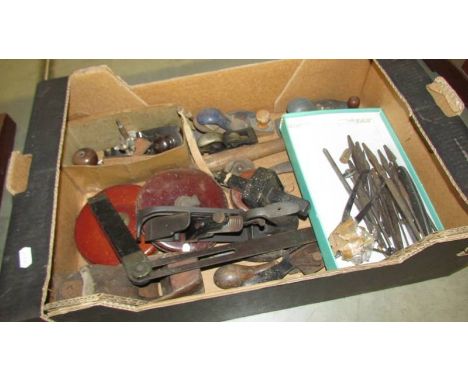 A box of vintage tools including planes, tape measures etc.,