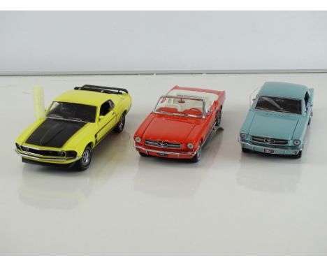 A group of diecast cars in 1:24 Scale by FRANKLIN MINT: comprising a 1964 Ford Mustang, a 1964 Ford Mustang Convertible and a