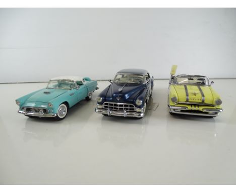 A group of diecast cars in 1:24 Scale by FRANKLIN MINT: comprising a 1955 Pontiac Starchief Convertible, a 1949 Cadillac Coup