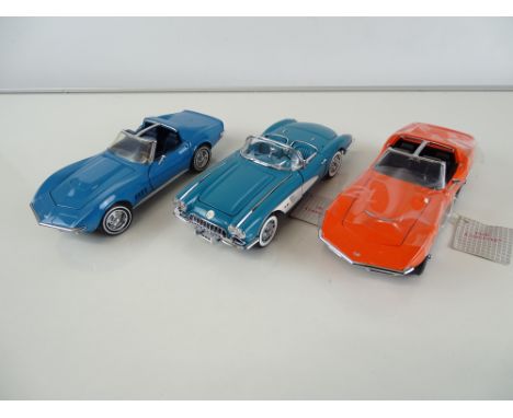 A group of diecast cars in 1:24 Scale by FRANKLIN MINT: comprising a 1968 Corvette Stingray, a 1960 Corvette and a 1969 Corve