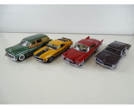 A group of diecast cars in 1:24 Scale by DANBURY MINT: comprising a 1953 Buick Estate Wagon, a 1970 Ford Mustang Mach 1, a 19