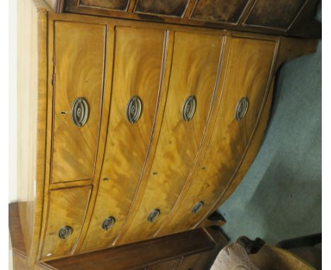 A walnut two over three bow front chest of drawers on bracket feet, 107cm high x 105cm wide x 52cm deep Condition Report: Ava