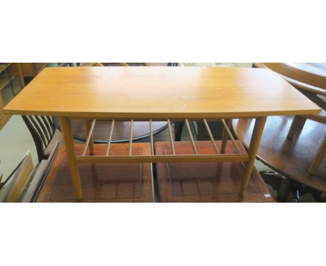 A Mid Century teak coffee table with magazine shelf, 46cm high x 107cm wide x 45cm deep Condition Report: Some damage and wea