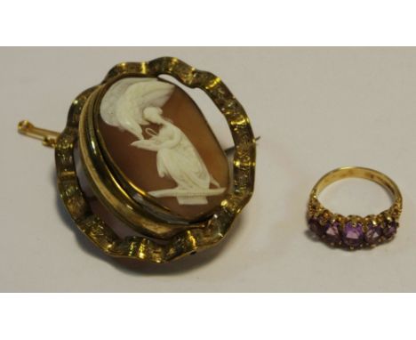 A 9ct gold ring set with five purple amethysts, 3.9g gross; a yellow metal swivel cameo brooch