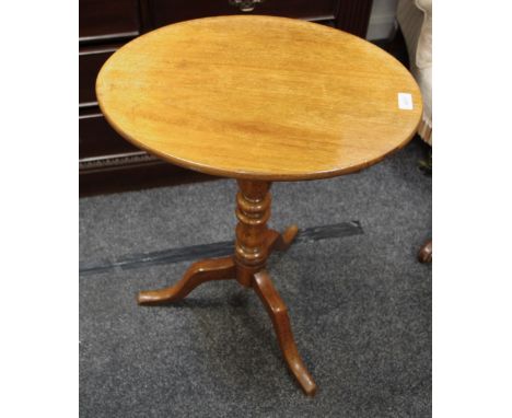 A mahogany oval tripod tilt-top table