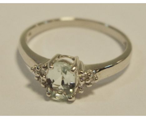 An 18ct white gold ring set with an oval tourmaline approx 0.56cts and six brilliant cut diamonds to shoulders, Birmingham, 2